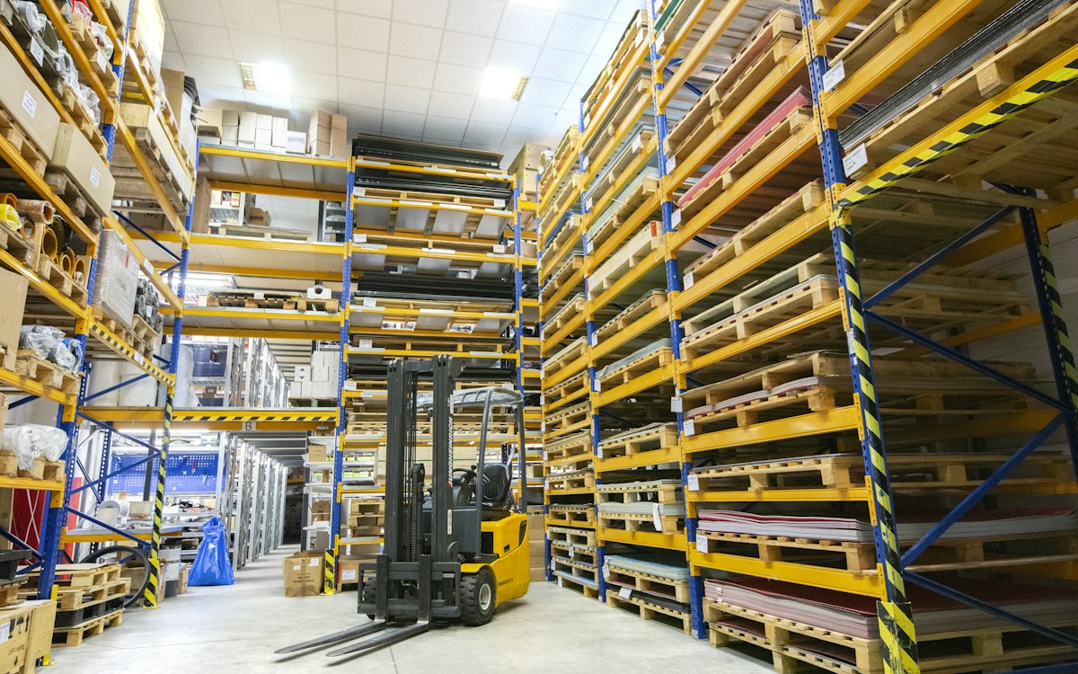Kho xưởng với giá kệ sắt và xe nâng